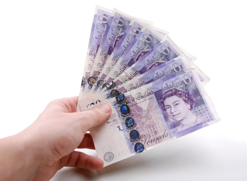 Photo of £20 notes being held