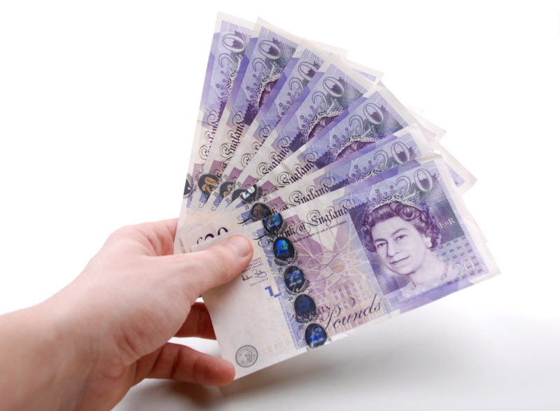 Photo of £20 notes being held